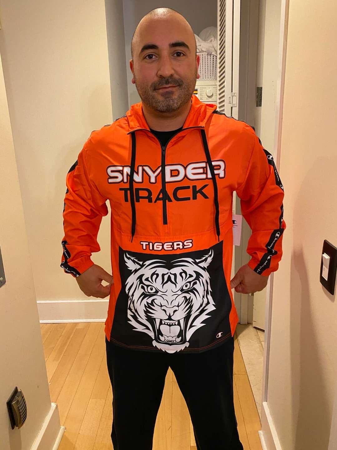 Coach Robert Arena wearing his orange Snyder Track jacket